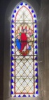 Christ healing the sick in window beside organ pipes