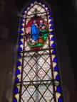 Christ feeding the 5 thousand window behind organ pipes